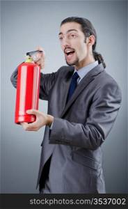 Man with fire extinguisher in firefighting concept