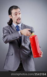 Man with fire extinguisher in firefighting concept