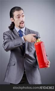 Man with fire extinguisher in firefighting concept