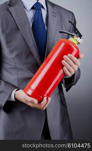 Man with fire extinguisher in firefighting concept