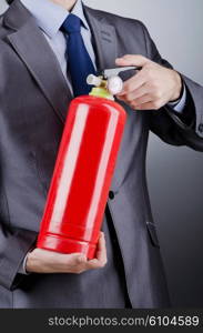 Man with fire extinguisher in firefighting concept