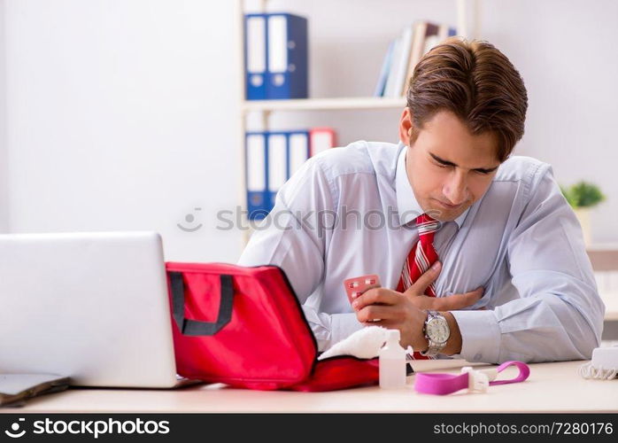 Man with first aid kit in the office