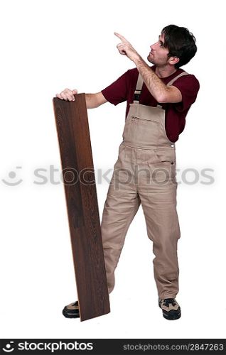 Man with flooring pointing at copyspace