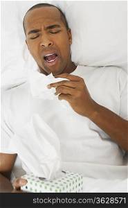 Man with flu in hospital bed