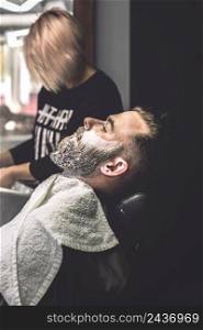 man with foam face barbershop