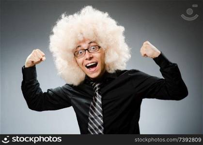 Man with funny hair style. Young man wearing afro wig