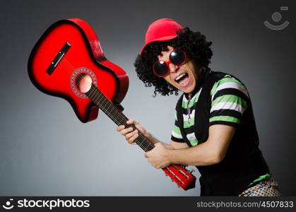 man with funny haircut and guitar