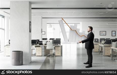 Man with growing graph. Businessman carrying graph bar growing concept in hands