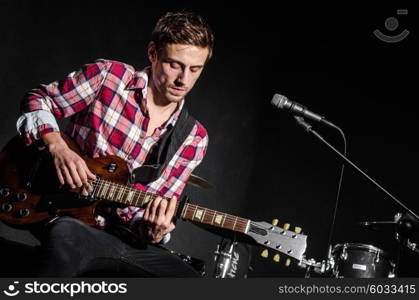 Man with guitar during concert