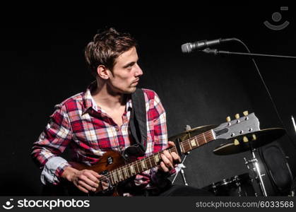 Man with guitar during concert