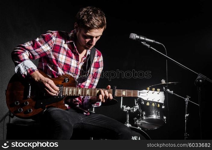 Man with guitar during concert