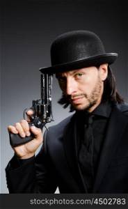 Man with gun and vintage hat