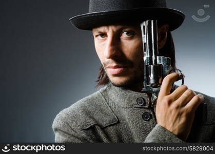 Man with gun and vintage hat