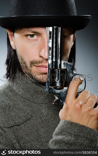 Man with gun and vintage hat