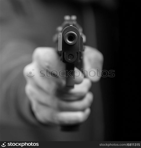 Man with gun, gangster, focus on the gun