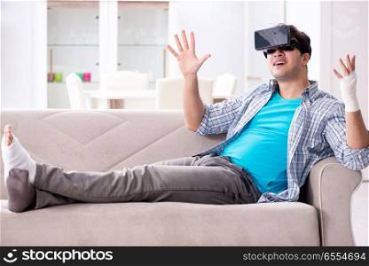 Man with hand injury wearing virtual reality glasses