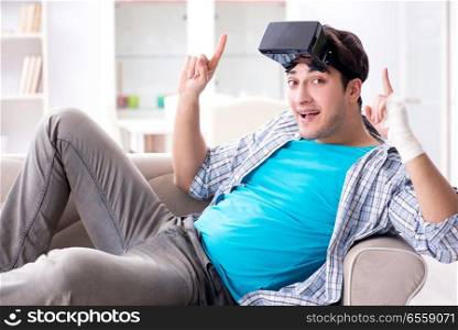 Man with hand injury wearing virtual reality glasses