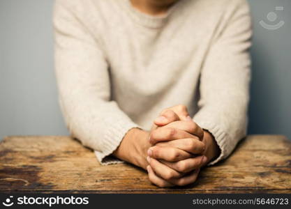 Man with hands folded in prayer