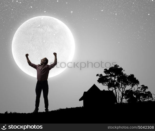 Man with hands up. Silhouette of screaming man celebrating success