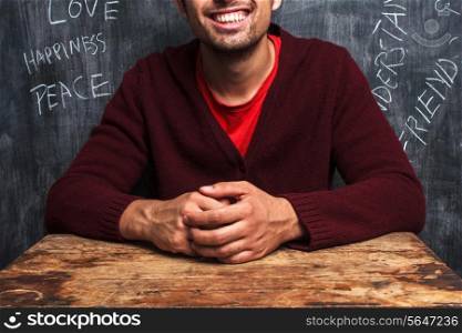 Man with happy words on blackboard