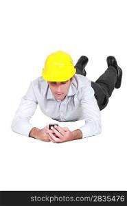 Man with hard hat looking at his mobile
