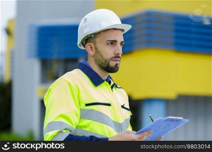 man with hard helmet and clipboard