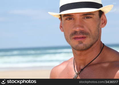 Man with hat on the beach