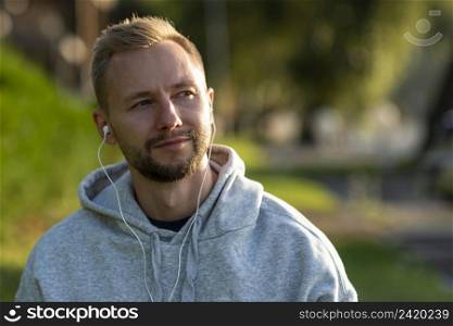 man with headphones relaxing outdoors