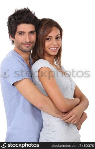 Man with his arms wrapped around his girlfriend
