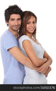 Man with his arms wrapped around his girlfriend