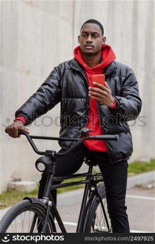 man with his bicycle using his mobile phone