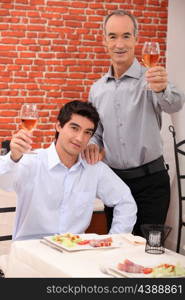 Man with his grandson eating in a restaurant