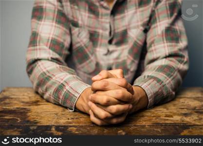 Man with his hands folded in prayer