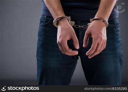 Man with his hands handcuffed in criminal concept. The man with his hands handcuffed in criminal concept