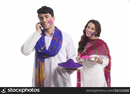 Man with holi colour talking on a mobile phone