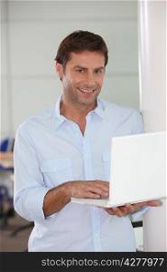 Man with laptop in hand