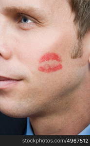 Man with lipstick kiss on cheek