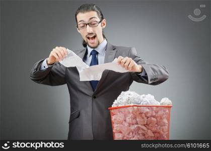 Man with lots of wasted paper
