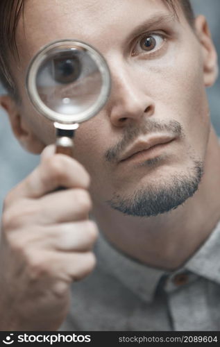 Man with magnifying glass. Vertical portrait