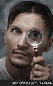 Man with magnifying glass. Vertical portrait