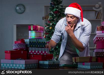 Man with many christmas gifts in boxes