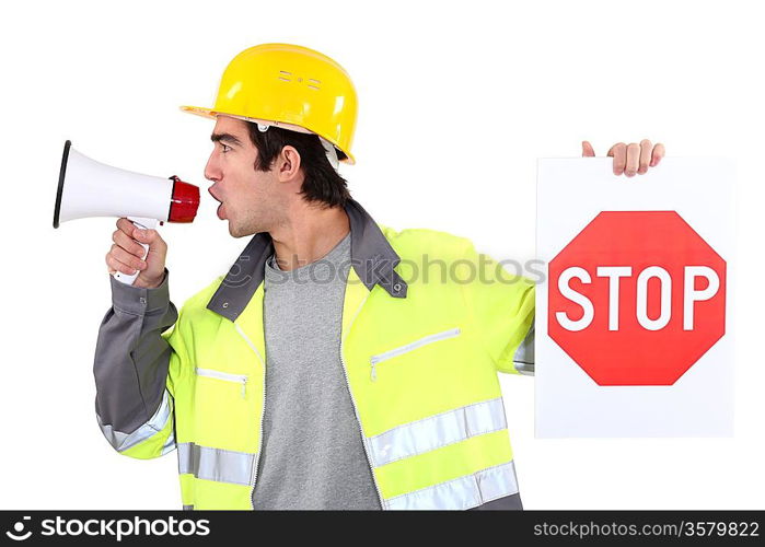Man with megaphone holding stop sign