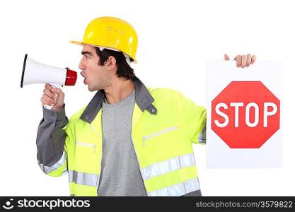 Man with megaphone holding stop sign