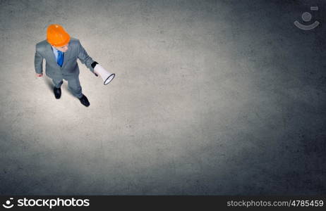 Man with megaphone. Top view of businessman screaming in megaphone