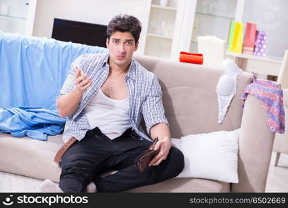 Man with mess at home after house party