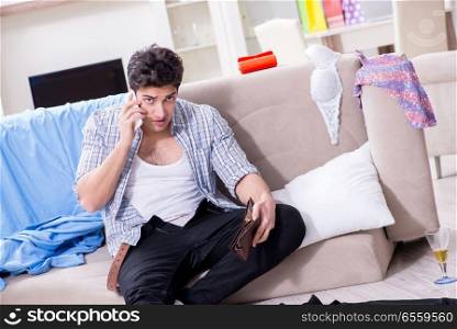 Man with mess at home after house party