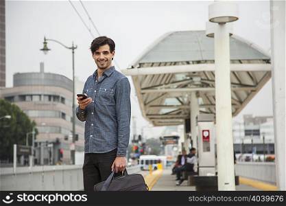 Man with mobile phone at station, Los Angeles, California, USA