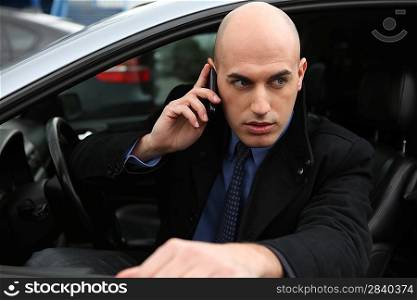 Man with mobile phone in car