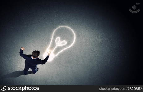 Man with mobile phone. Top view of young businessman using mobile phone