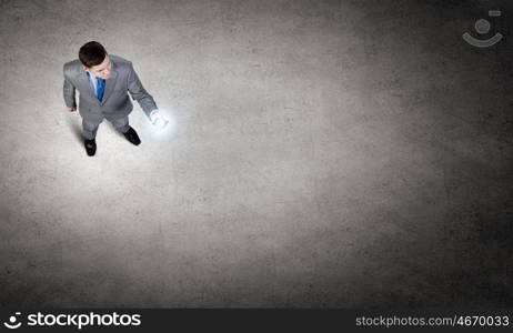 Man with mobile phone. Top view of young businessman using mobile phone